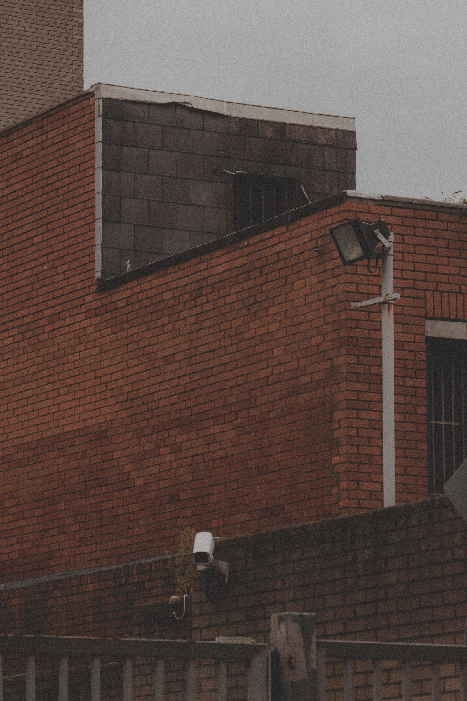 Outdoor dome and bullet cameras on a brick commercial building
